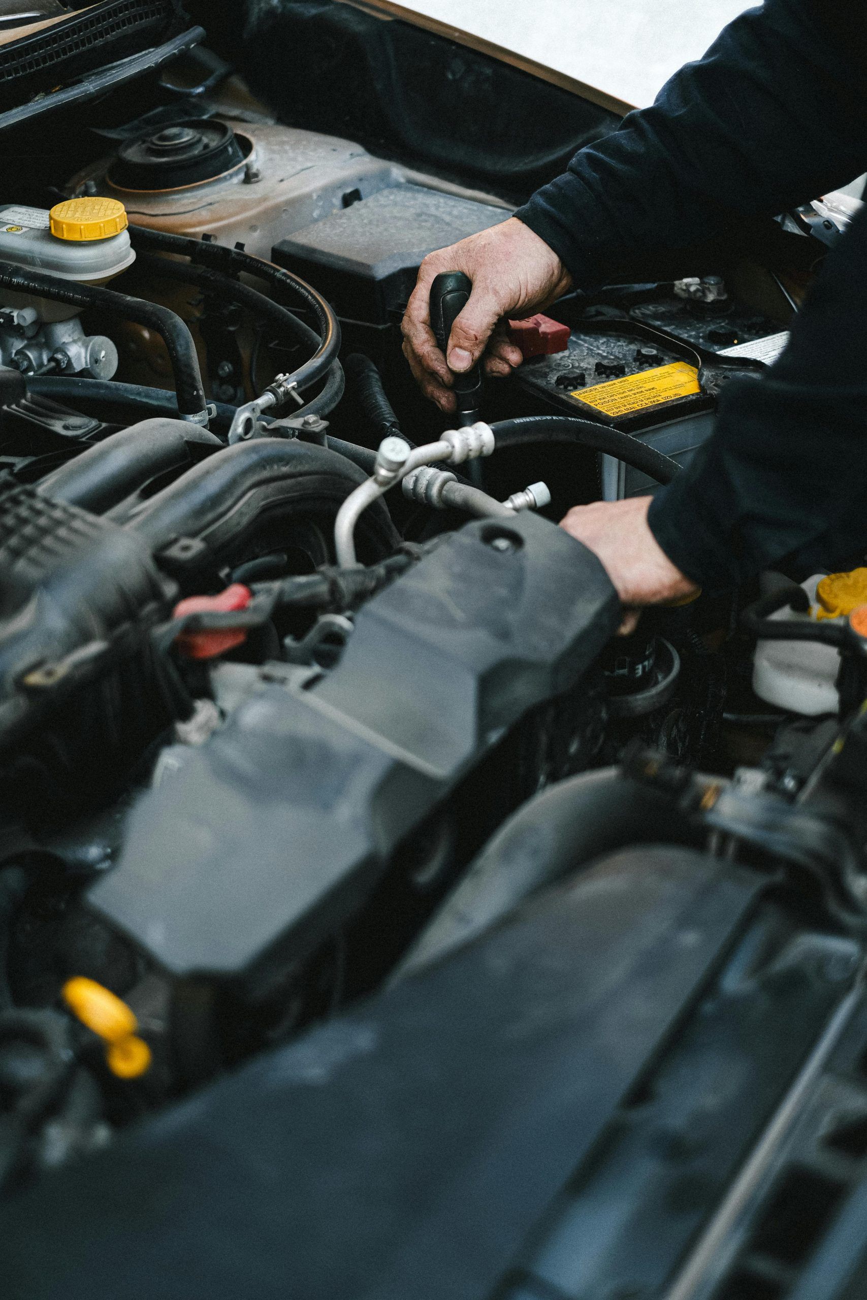 Mechanic working in a car's engine bay
